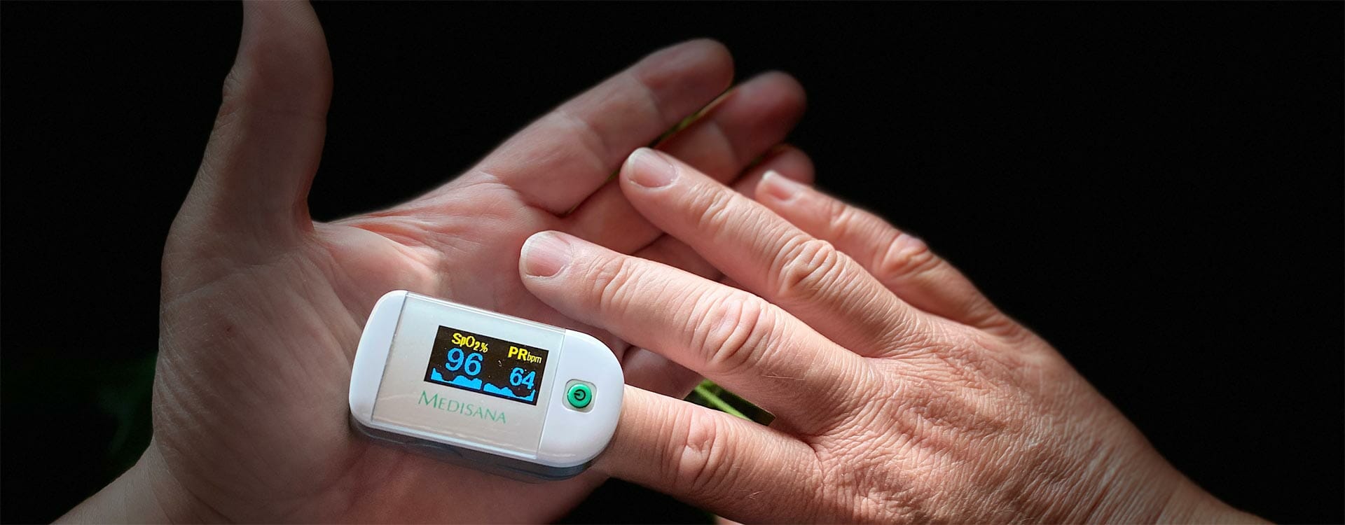 Lungenfibrose: Hand eines Mannes mit Oximeter